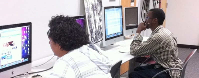 Student interns learning and working on Mac computers